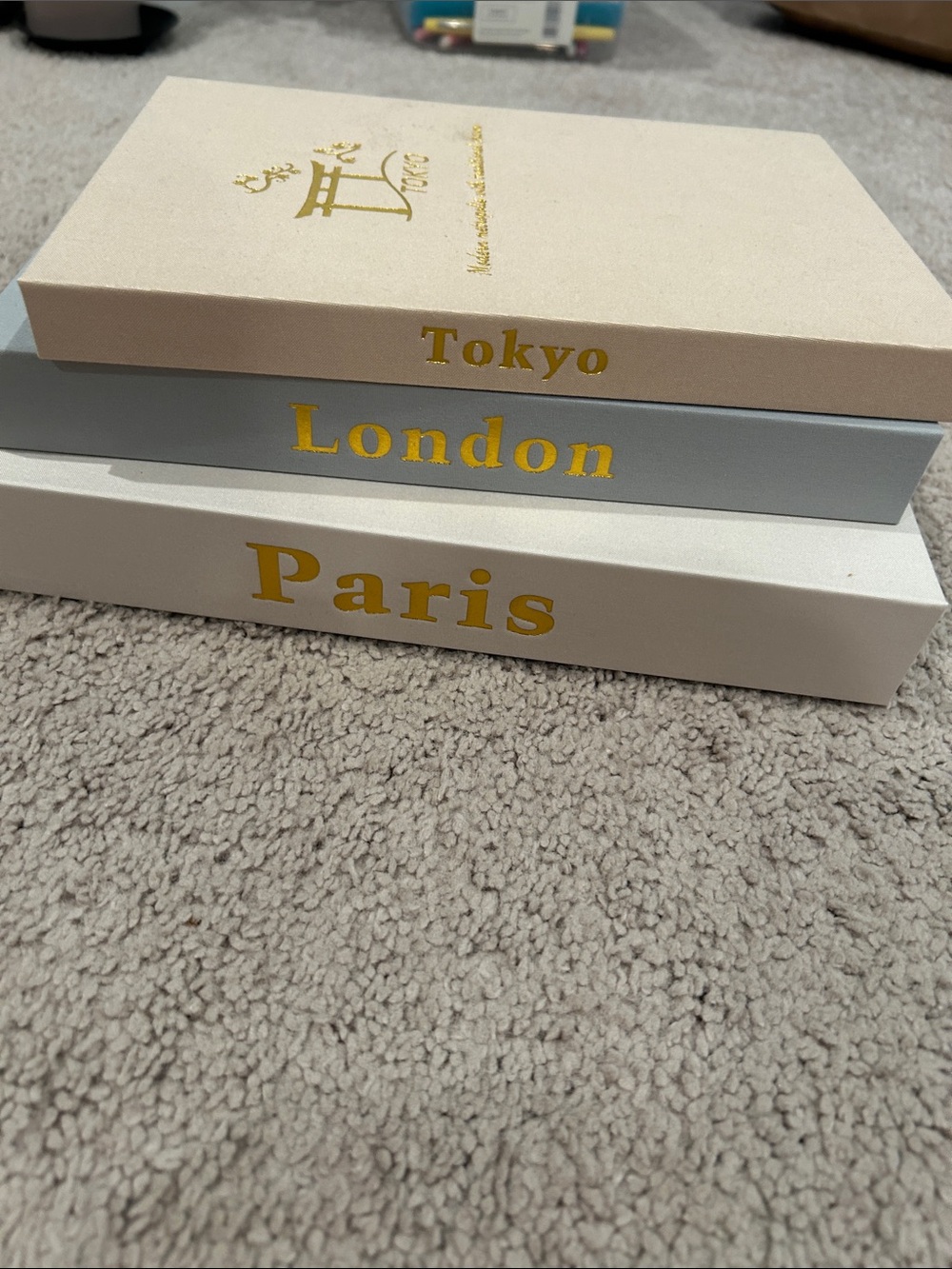 Source Unknown Beige, Gray, White City Book Stack with Gold Accents